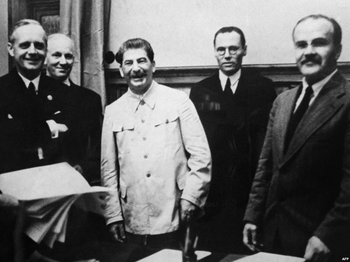 German Foreign Minister Joachim Von Ribbentrop (left), Soviet leader Josef Stalin, and Soviet Foreign Minister Vyacheslav Molotov (right) meet at the Kremlin on August 23, 1939, to sign the nonaggression pact