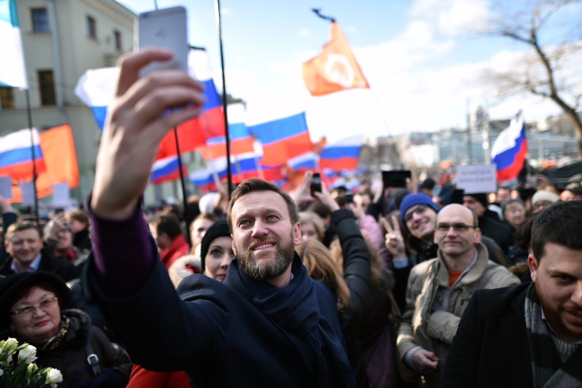 Russian opposition leader and anti-corruption blogger Alexei Navalny takes a selfie picture as he attends a memorial march marking the one-year anniversary of the assassination of Russian politician Boris Nemtsov in central Moscow, on February 27, 2016. Nemtsov, a former deputy prime minister in the government of Boris Yeltsin, was gunned down shortly before midnight on February 27, 2015, while walking across a bridge a short distance from the Kremlin with his Ukrainian model girlfriend. AFP PHOTO / KIRILL KUDRYAVTSEV / AFP / KIRILL KUDRYAVTSEV (Photo credit should read KIRILL KUDRYAVTSEV/AFP/Getty Images)